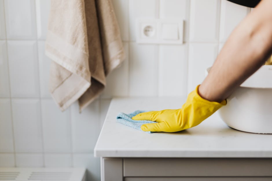 house cleaner wiping, sanitizing bathroom sink house cleaner wiping, sanitizing bathroom sink